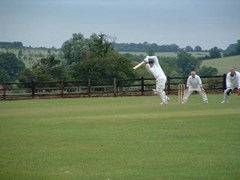 Fergie shows his team how to ball the off drive... High elbow, with ball screaming thr the covers....