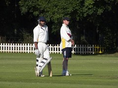 Adil Parker rests on his bat while Phil Bush umpires during our game at Lydney, Aug 2009
