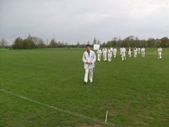 Liang Wenbo leads off the players at the end of the innings