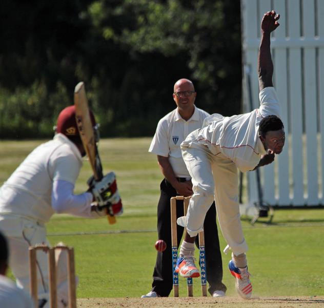 Hutton's Carl Mumba bowling against Oakfield Parkonians