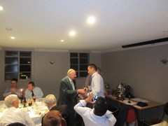 Honorary President John McHardy presents the 1st XI batting and bowling awards to Aman Arora 
