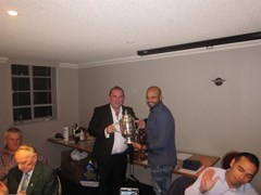 1994 Strathmore Union winning captain Henry Cruickshank presents the Earl of Strathmore Trophy to 2016 SPCU NE Championship winning captain Swapnil Rane
