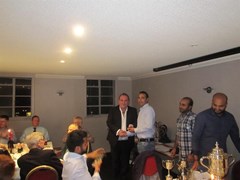 1994 Strathmore Union winning captain Henry Cruickshank presents a medal to Aman Arora