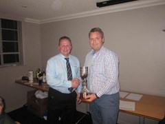 Club President Andy Lowden hands over the Trophy to Jamie McCabe