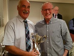 Gordonian Association Vice President Walter Stephen with the Bon Accord Cup presenting a medal to Gerry O'Brien