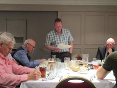 Club President Andy Lowden opens the evening while Alan Adie, George Bews and Paul Gray listen intently